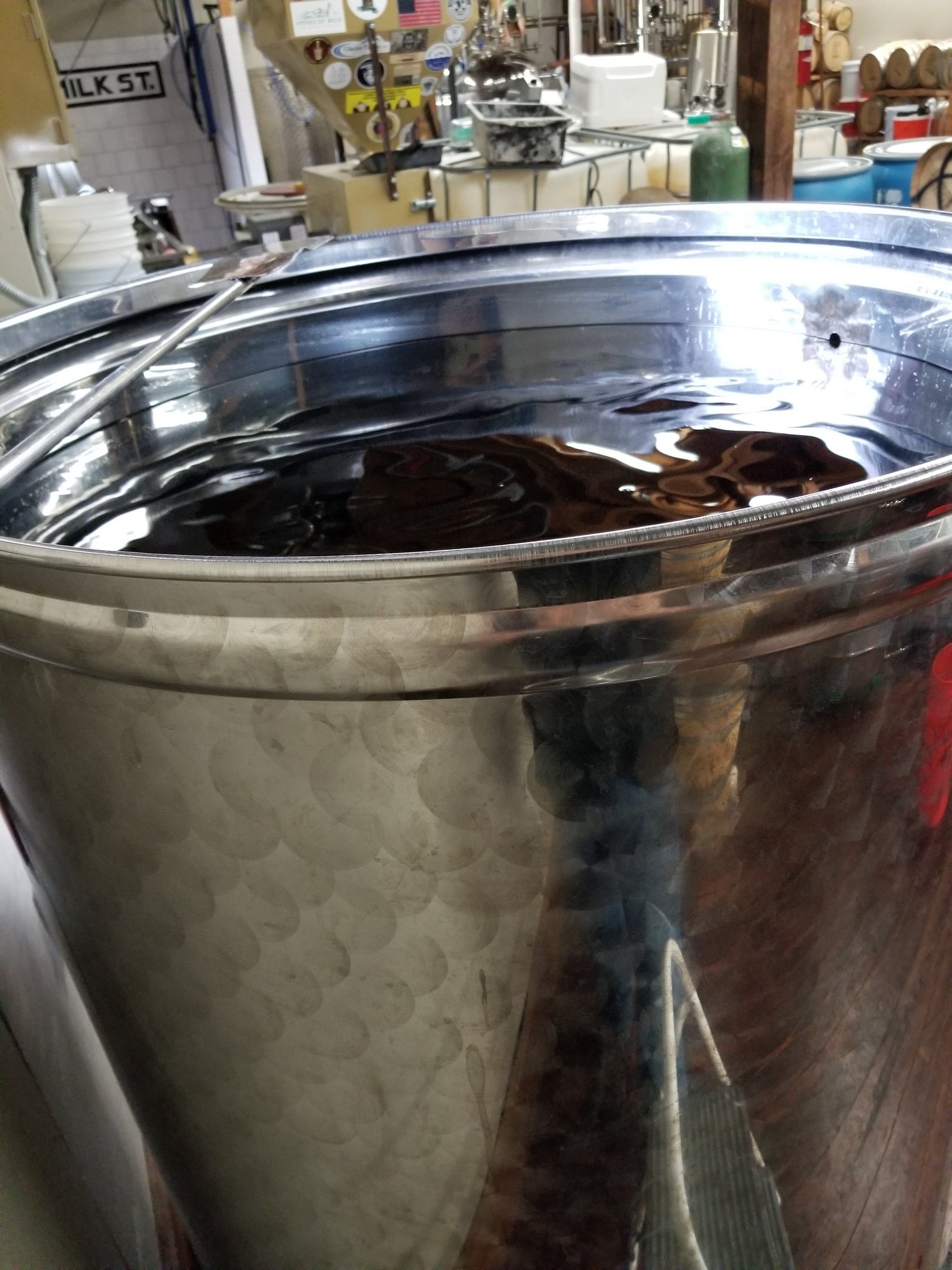 Two copper column stills and the fermenters beside them.