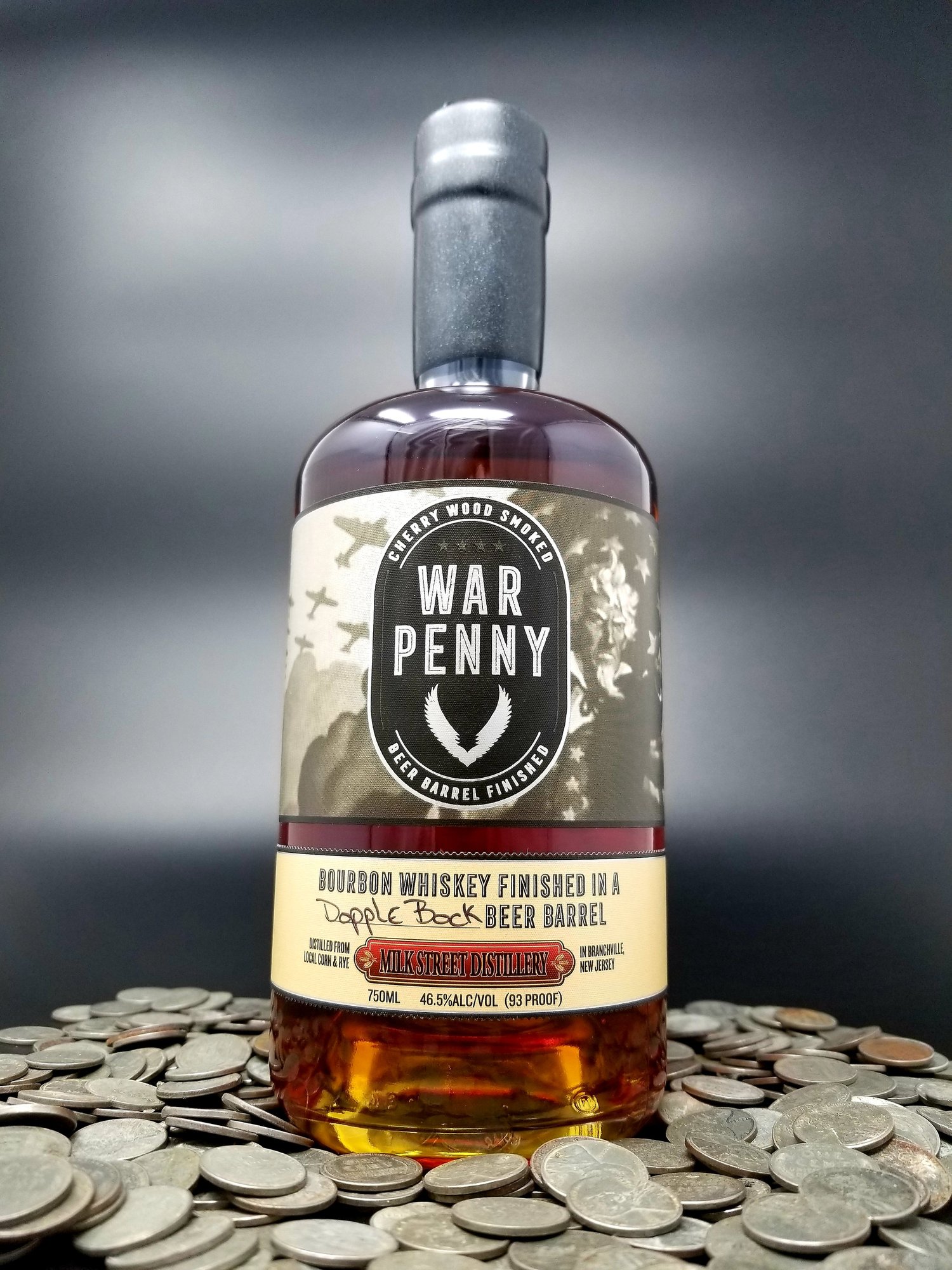 War Penny bottle on black, black wax sealed with a 1943 steel penny.